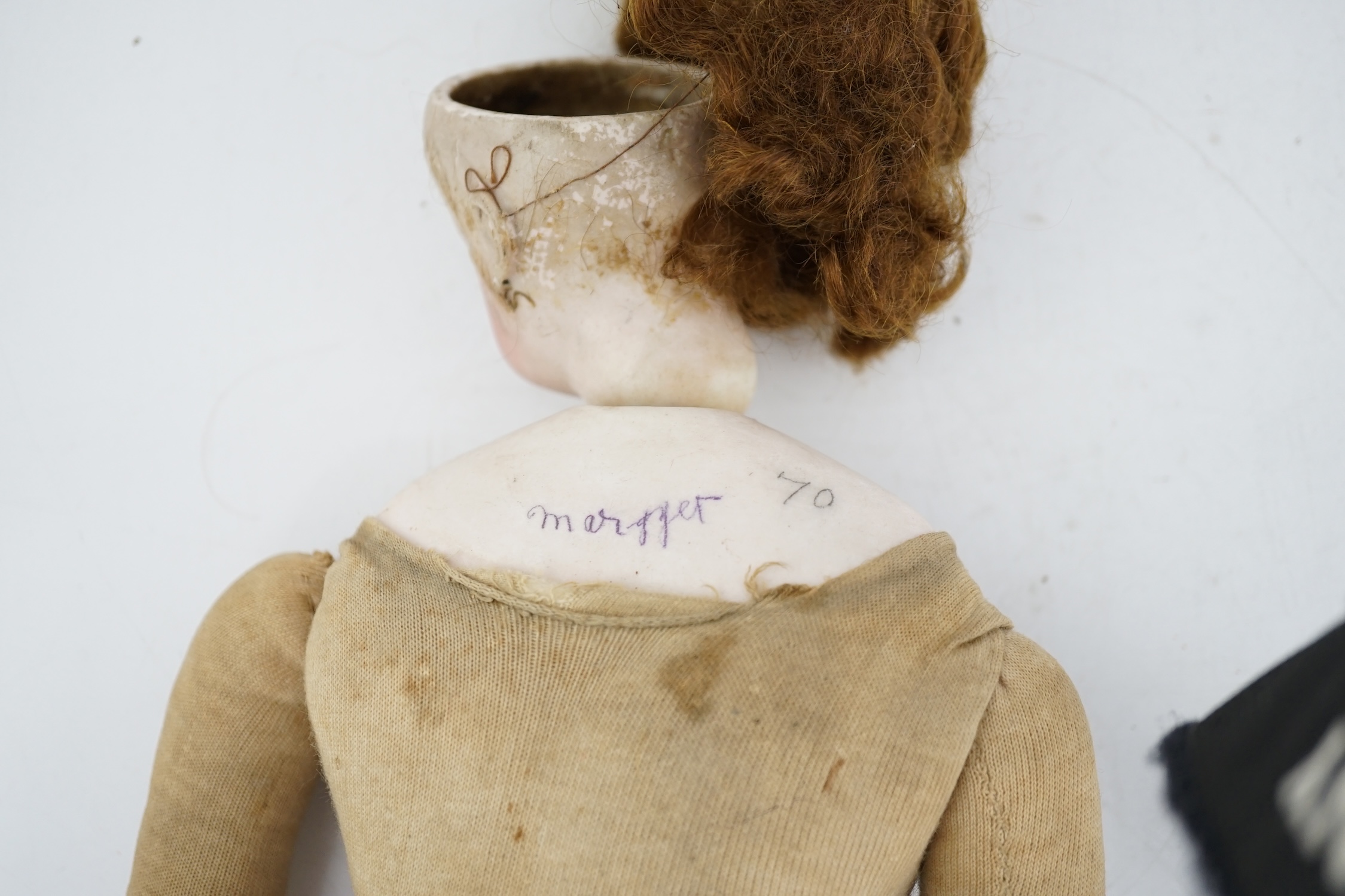A late 19th century French biscuit head doll, possibly Simon & Halbig, with cloth body, bisque hands, 45cm high, eye and ear chip
